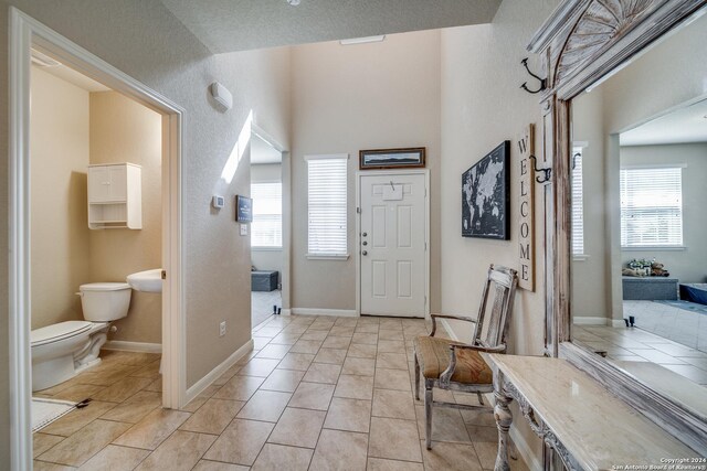 foyer entrance featuring light tile patterned flooring and plenty of natural light