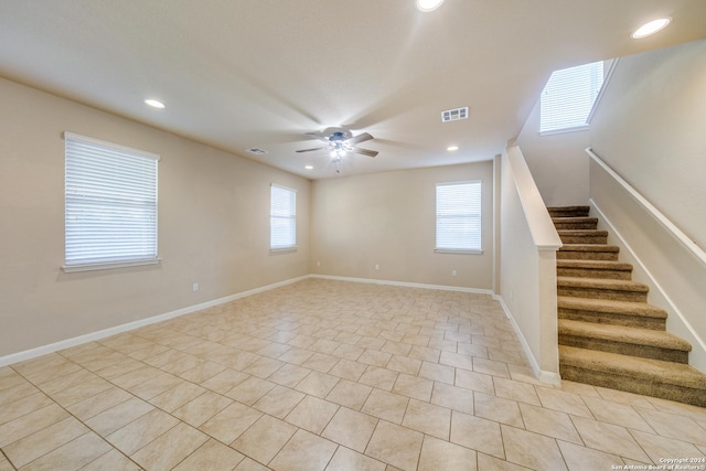 tiled spare room with ceiling fan