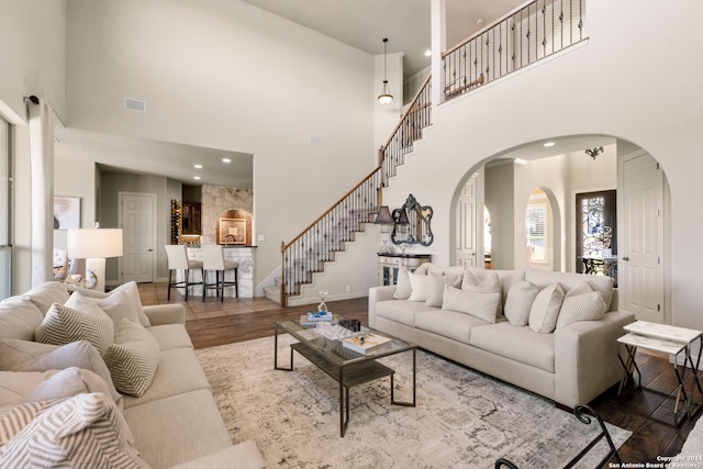 living room with a high ceiling and wood-type flooring