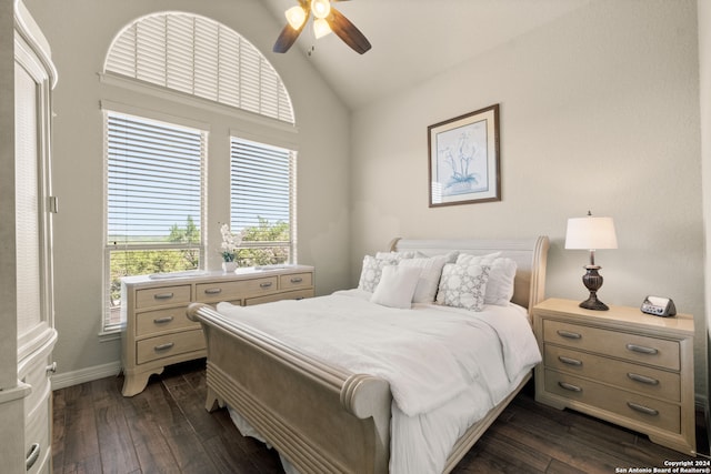 bedroom featuring dark hardwood / wood-style flooring, vaulted ceiling, and ceiling fan