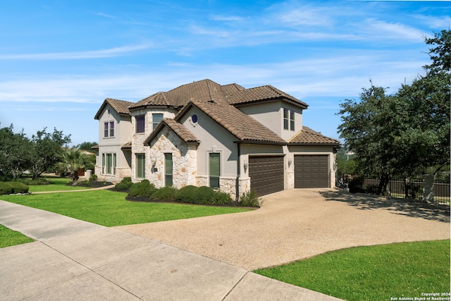 mediterranean / spanish-style house featuring a garage and a front yard