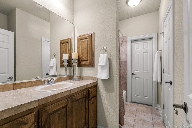 bathroom with tile patterned flooring, washtub / shower combination, a textured ceiling, and vanity