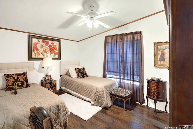 bedroom featuring crown molding, dark wood-type flooring, and ceiling fan