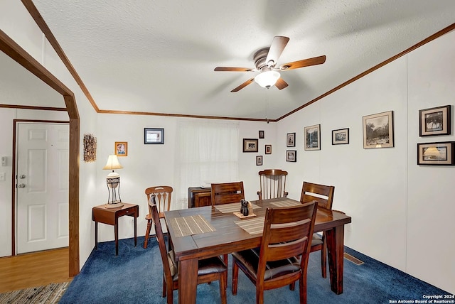 dining area featuring ceiling fan, crown molding, a textured ceiling, and carpet