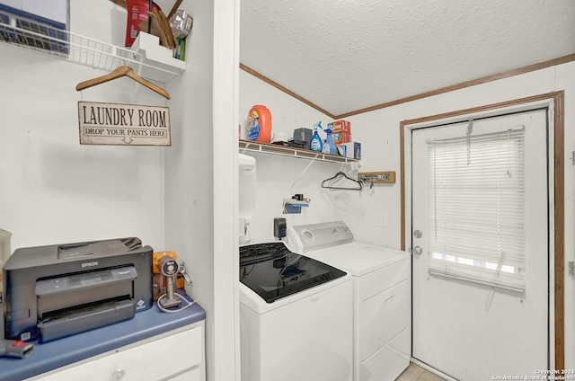 clothes washing area featuring crown molding, a textured ceiling, and washing machine and clothes dryer