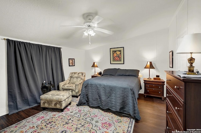 bedroom featuring lofted ceiling, dark wood-type flooring, and ceiling fan