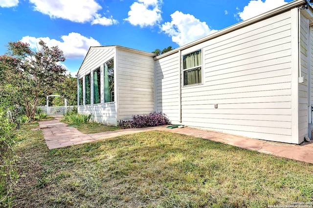 view of property exterior with a yard