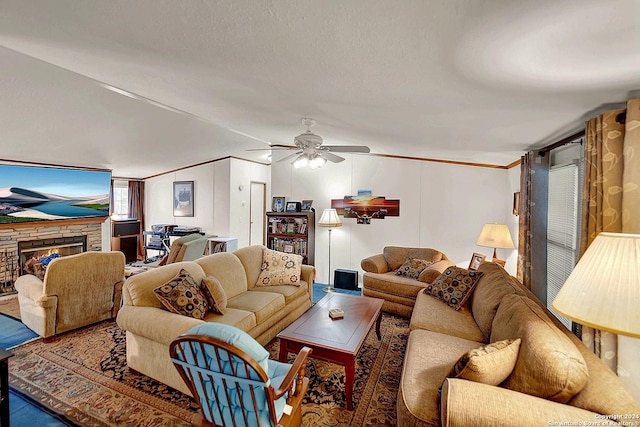 living room featuring crown molding, a fireplace, a textured ceiling, and ceiling fan