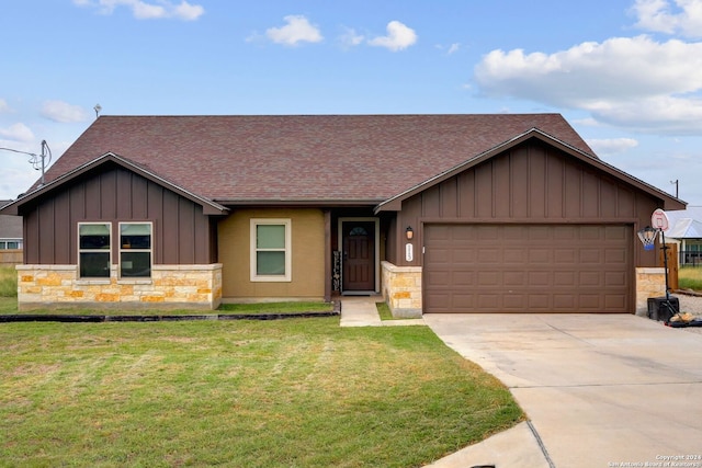 ranch-style house featuring a garage and a front lawn