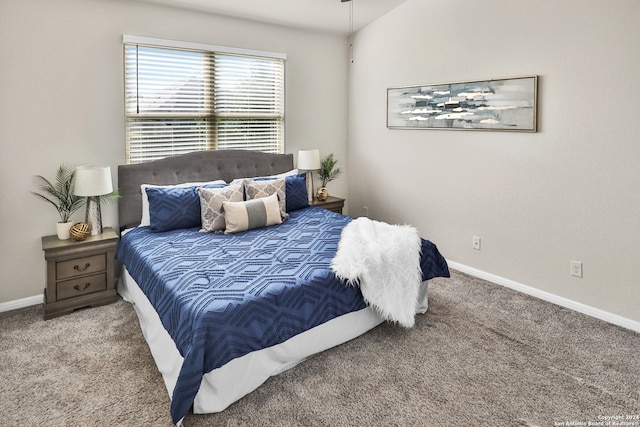 bedroom featuring carpet flooring and lofted ceiling