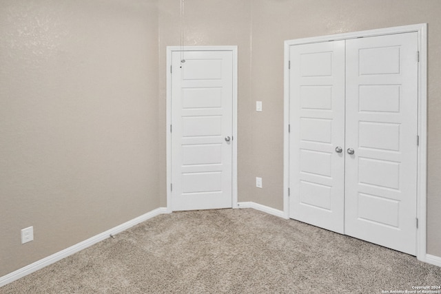 unfurnished bedroom featuring a closet and carpet floors