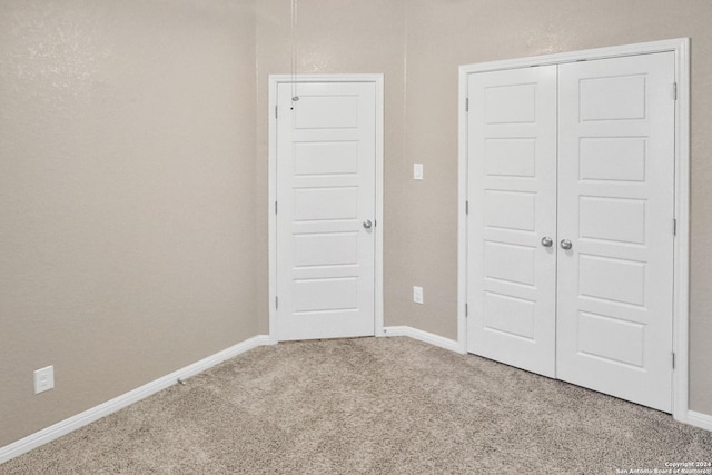 unfurnished bedroom featuring a closet and carpet flooring