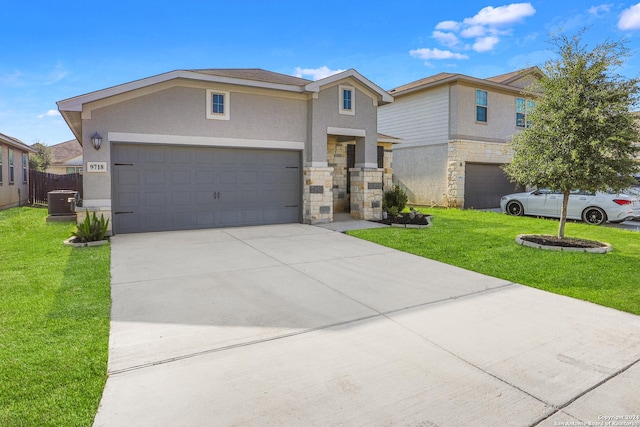 view of front of property featuring a garage, central AC, and a front yard