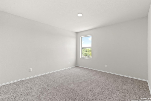 empty room with carpet flooring and baseboards