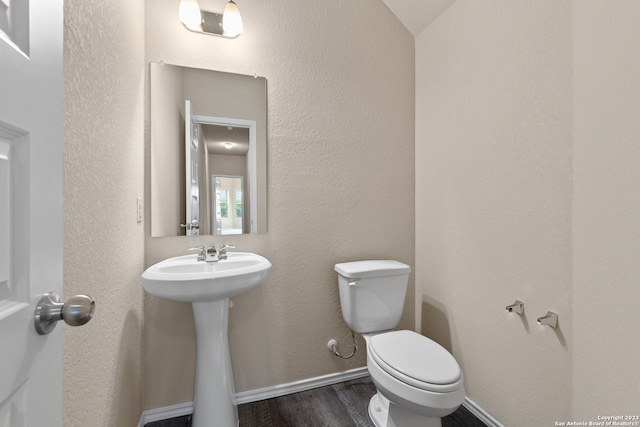 bathroom with toilet and hardwood / wood-style floors