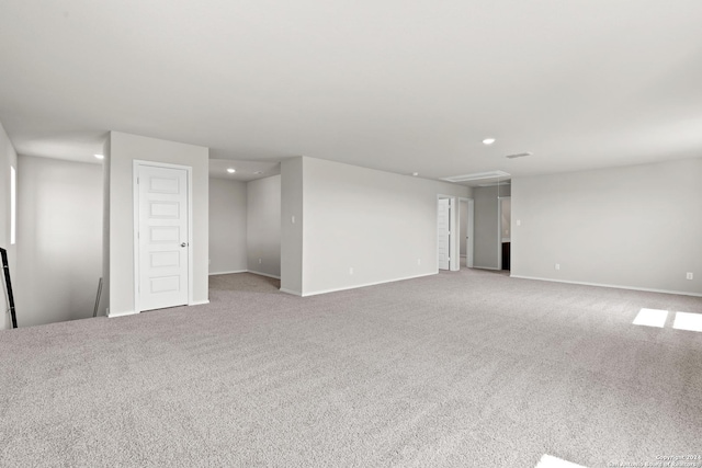 carpeted empty room with baseboards and recessed lighting