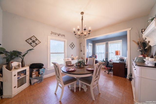 dining area with light parquet flooring and a chandelier