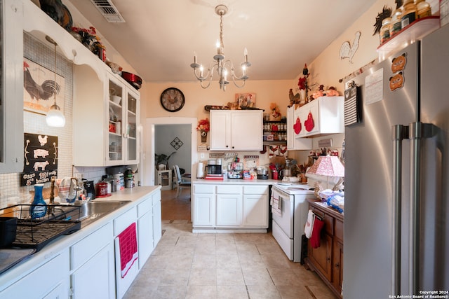 kitchen featuring high quality fridge, white cabinetry, light tile patterned floors, decorative backsplash, and pendant lighting