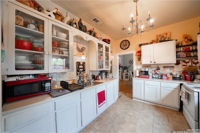 kitchen featuring sink, hanging light fixtures, and white cabinets