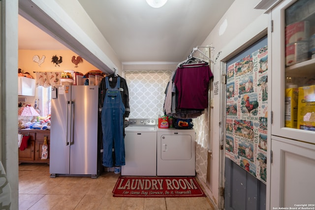 washroom featuring light tile patterned flooring and washer and clothes dryer