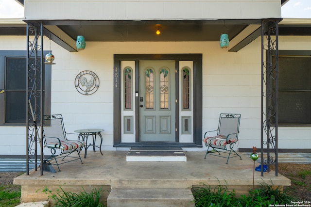 view of exterior entry with a porch