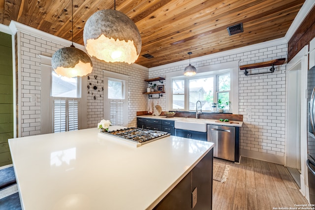 kitchen featuring stainless steel appliances, brick wall, sink, light hardwood / wood-style floors, and wood ceiling