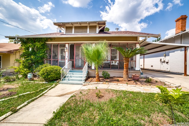 view of front of home with a sunroom