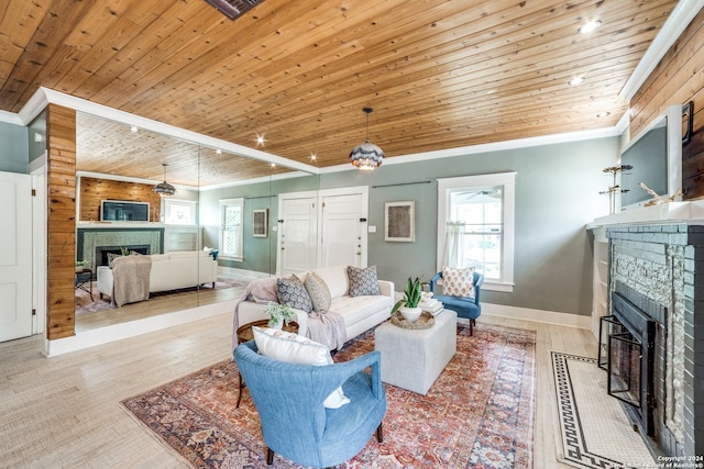 living room with ornamental molding, wooden ceiling, and light wood-type flooring