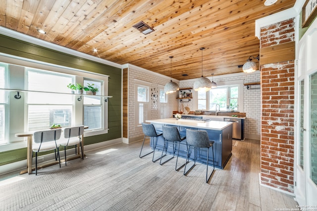 kitchen featuring brick wall, wooden ceiling, and hanging light fixtures