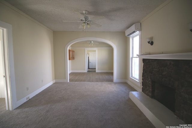 unfurnished living room with an AC wall unit, light carpet, ceiling fan, and a textured ceiling