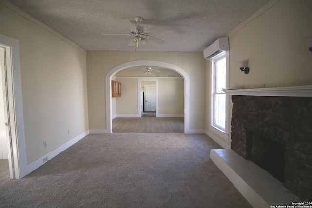 unfurnished living room with arched walkways, a ceiling fan, light colored carpet, a wall mounted air conditioner, and a fireplace