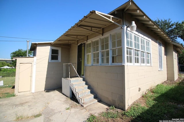 exterior space with concrete block siding