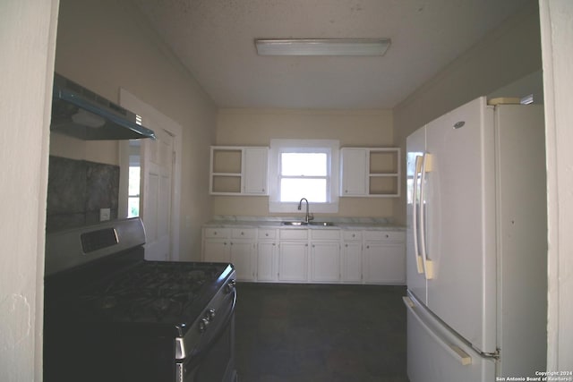 kitchen with open shelves, gas stove, freestanding refrigerator, and white cabinetry