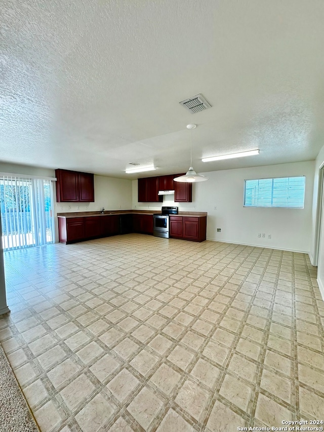 unfurnished living room featuring light tile patterned flooring and a textured ceiling