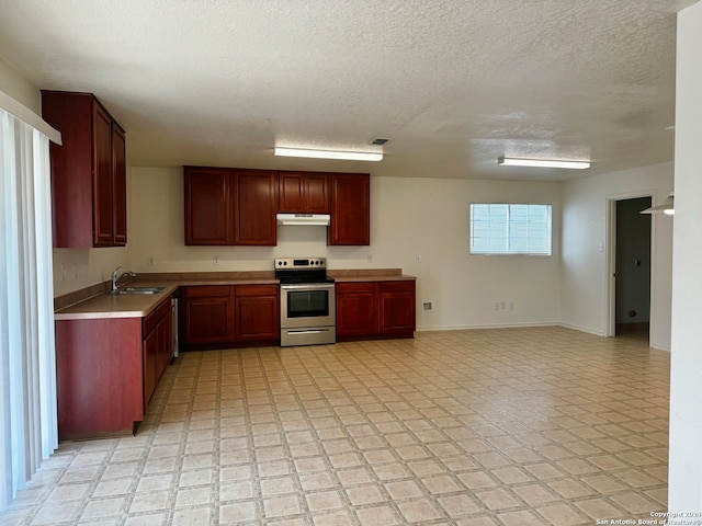 kitchen featuring electric range, sink, a textured ceiling, and light tile patterned floors