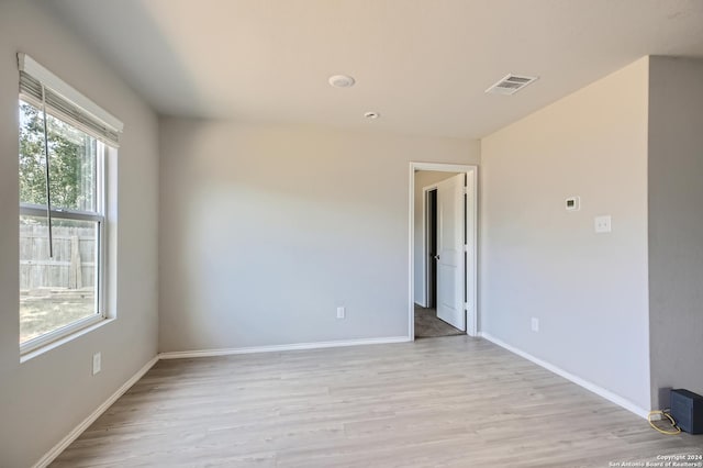 spare room with light hardwood / wood-style flooring