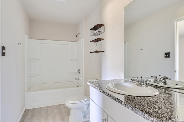 full bathroom with vanity, wood-type flooring, bathtub / shower combination, and toilet