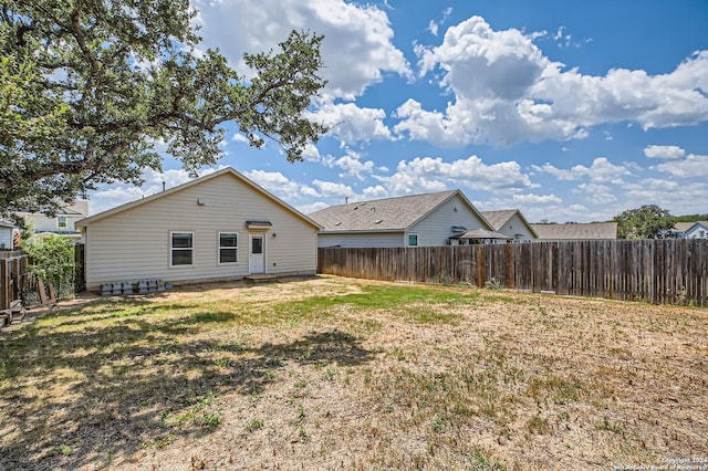 rear view of house with a yard