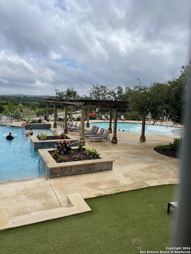 view of pool featuring a patio area