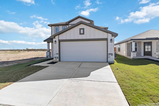 view of front of house featuring a garage and a front lawn