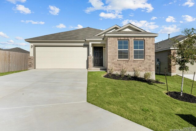 view of front of home with a garage and a yard