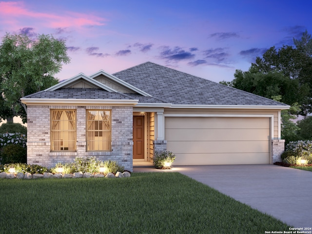 view of front of home featuring a garage and a yard