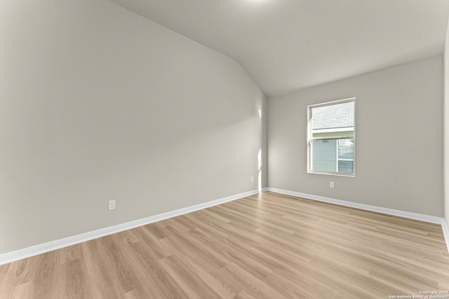 empty room featuring light hardwood / wood-style floors and lofted ceiling