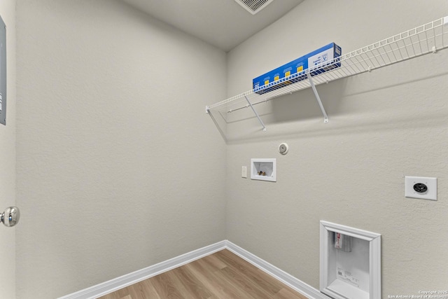 clothes washing area featuring washer hookup, hardwood / wood-style flooring, electric dryer hookup, and hookup for a gas dryer