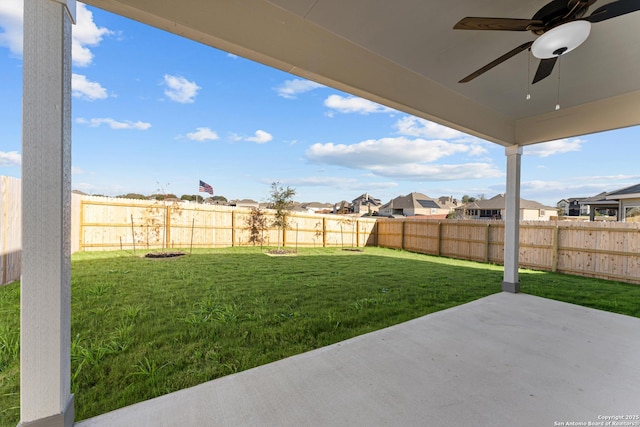 view of yard featuring ceiling fan and a patio area