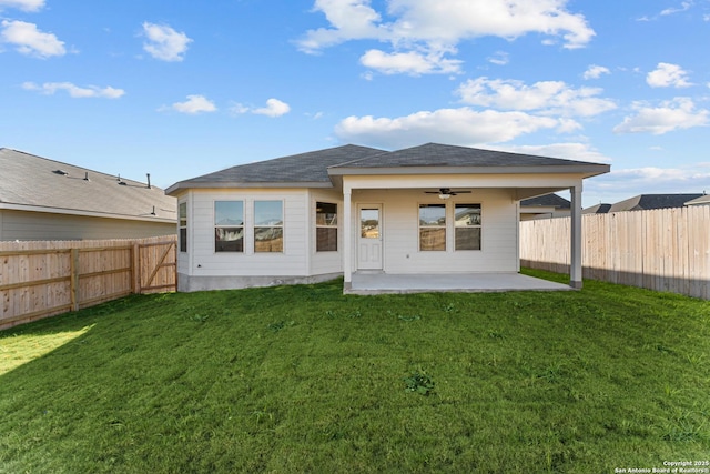 back of property featuring ceiling fan, a patio, and a lawn