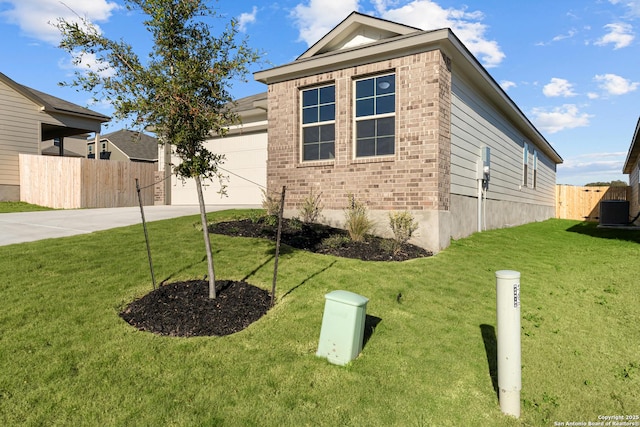 view of side of home with a yard and cooling unit