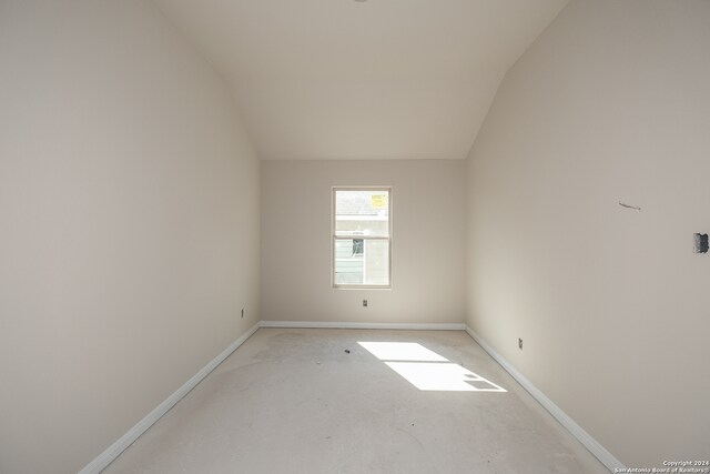 spare room with lofted ceiling