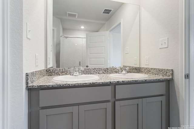 bathroom featuring vanity and a shower with shower door