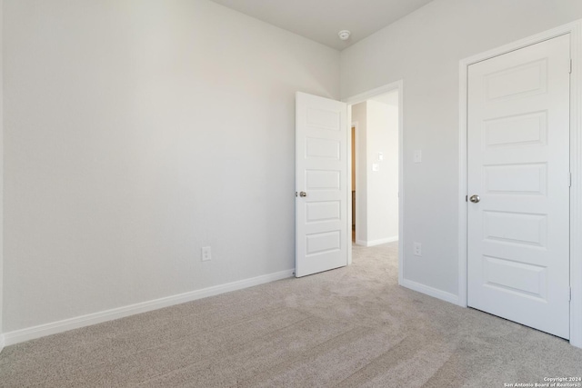 unfurnished bedroom with light carpet